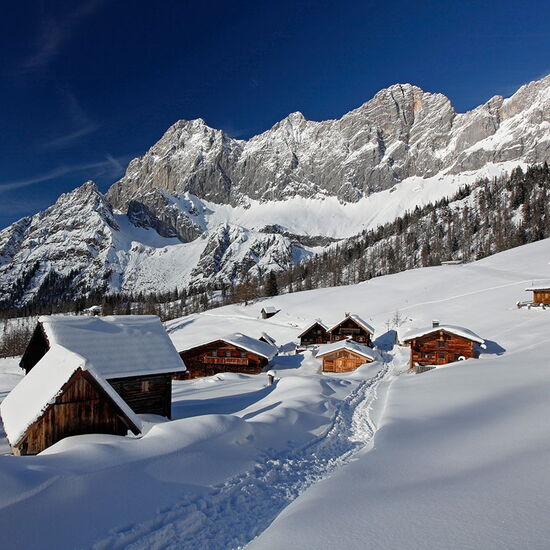 Alpine huts in deep snow